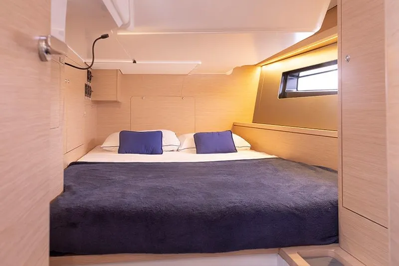  Yacht Photos Pics Luxurious cabin interior of 2025 Dufour 44 yacht with cozy bedding and modern design.