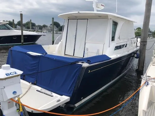  Yacht Photos Pics 2014 Back Cove 41 yacht docked, featuring a sleek design and blue cover.