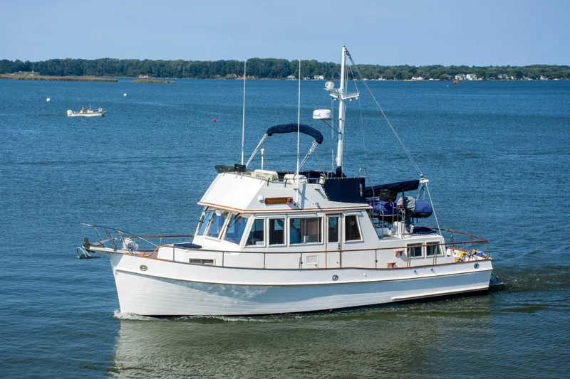  Yacht Photos Pics 1990 Grand Banks 36 Classic yacht cruising on calm blue waters.