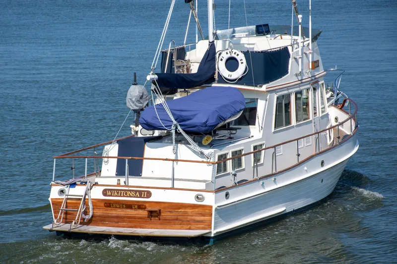  Yacht Photos Pics 1990 Grand Banks 36 Classic yacht cruising on calm waters, rear view.