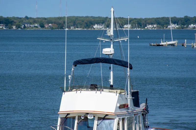  Yacht Photos Pics 1990 Grand Banks 36 Classic boat on calm water with distant shoreline.