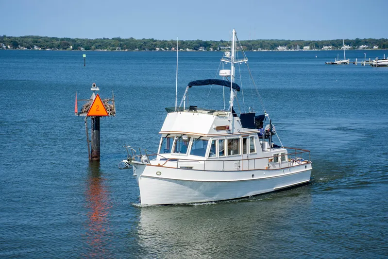  Yacht Photos Pics 1990 Grand Banks 36 Classic yacht cruising on a calm blue lake.
