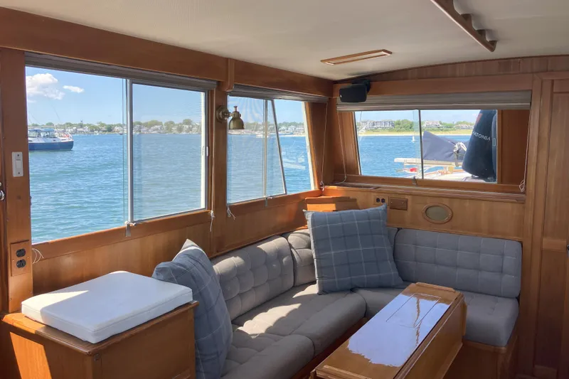  Yacht Photos Pics Interior of 1990 Grand Banks 36 Classic yacht with cozy seating and scenic water view.