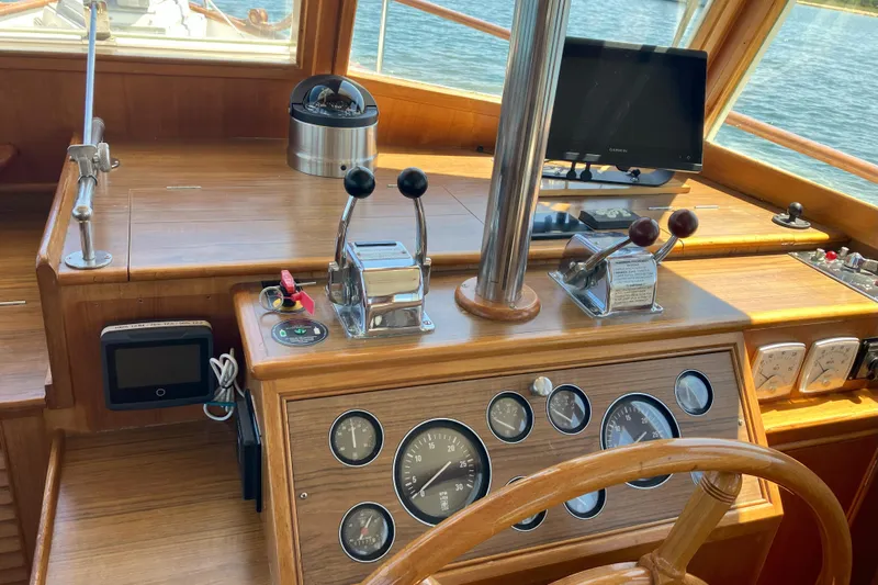  Yacht Photos Pics Helm of 1990 Grand Banks 36 Classic yacht with wooden dashboard and navigation instruments.