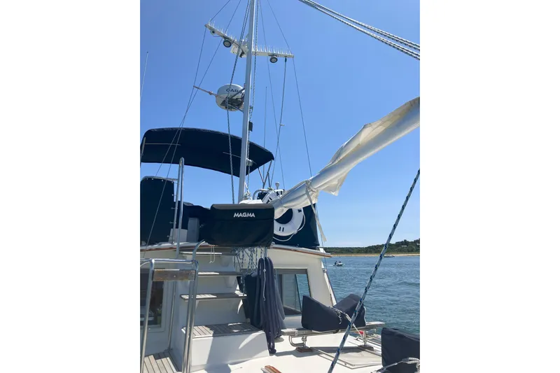  Yacht Photos Pics 1990 Grand Banks 36 Classic yacht with radar and blue canopy on a sunny day.