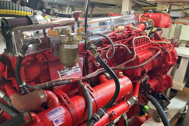  Yacht Photos Pics Engine room of a 1990 Grand Banks 36 Classic, showcasing a red marine engine.