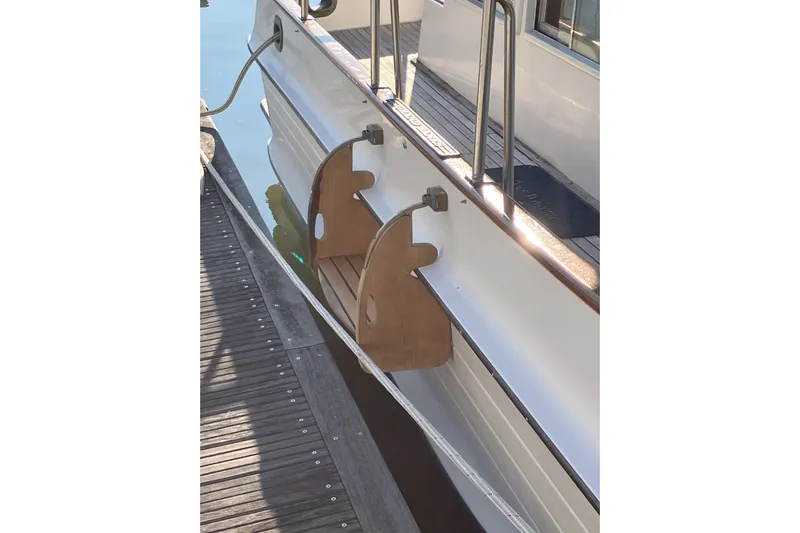  Yacht Photos Pics 1990 Grand Banks 36 Classic boat with wooden boarding steps at dockside.