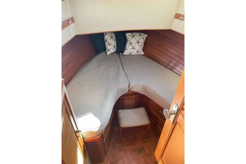  Yacht Photos Pics Cozy cabin interior of 1990 Grand Banks 36 Classic with wooden paneling and twin beds.