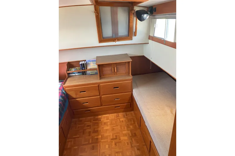  Yacht Photos Pics Cozy cabin interior of 1990 Grand Banks 36 Classic with wooden furniture and books.