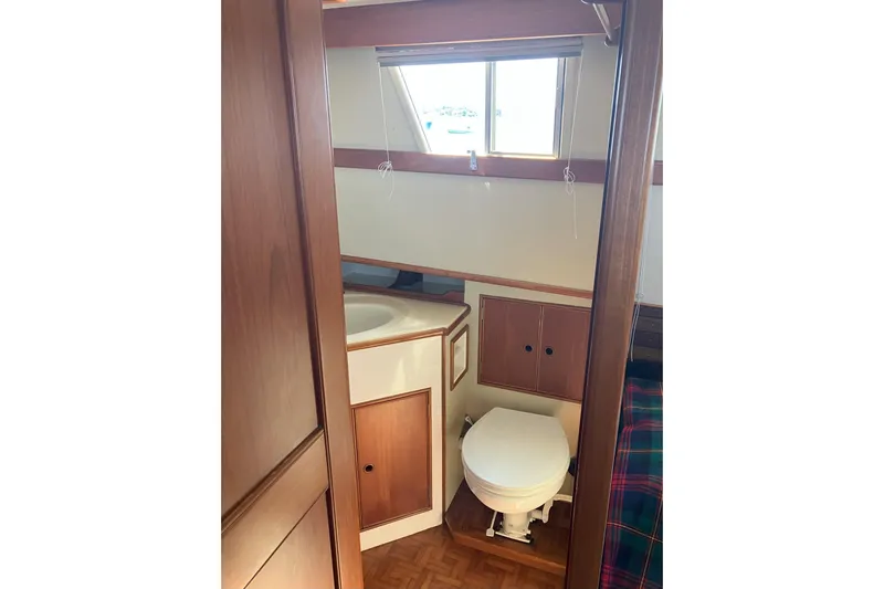  Yacht Photos Pics 1990 Grand Banks 36 Classic yacht bathroom with wooden cabinetry and window.