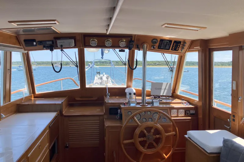  Yacht Photos Pics Interior view of 1990 Grand Banks 36 Classic yacht helm with wooden steering wheel.