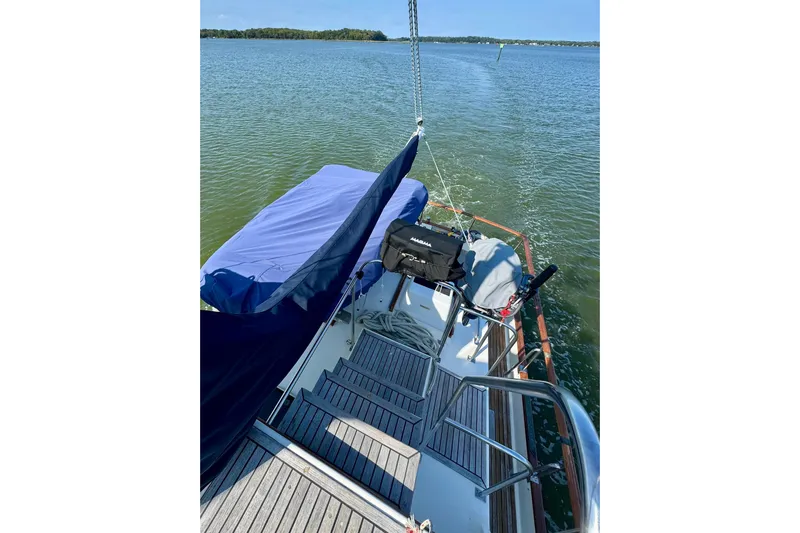  Yacht Photos Pics 1990 Grand Banks 36 Classic yacht on calm water, featuring a covered deck and scenic view.