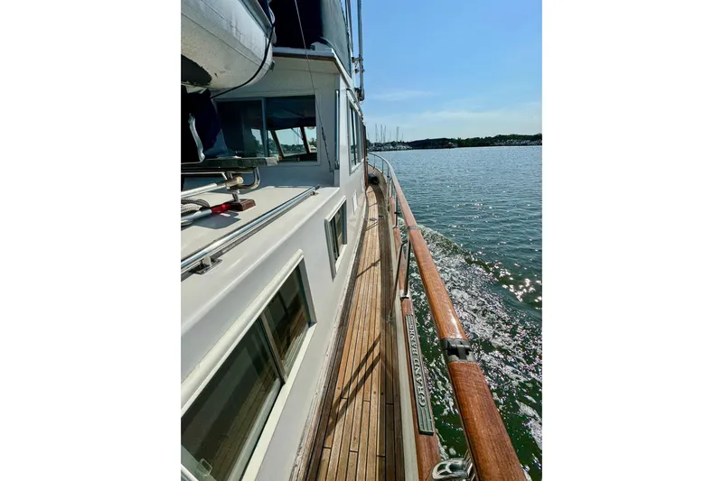  Yacht Photos Pics Side view of 1990 Grand Banks 36 Classic yacht on calm water.
