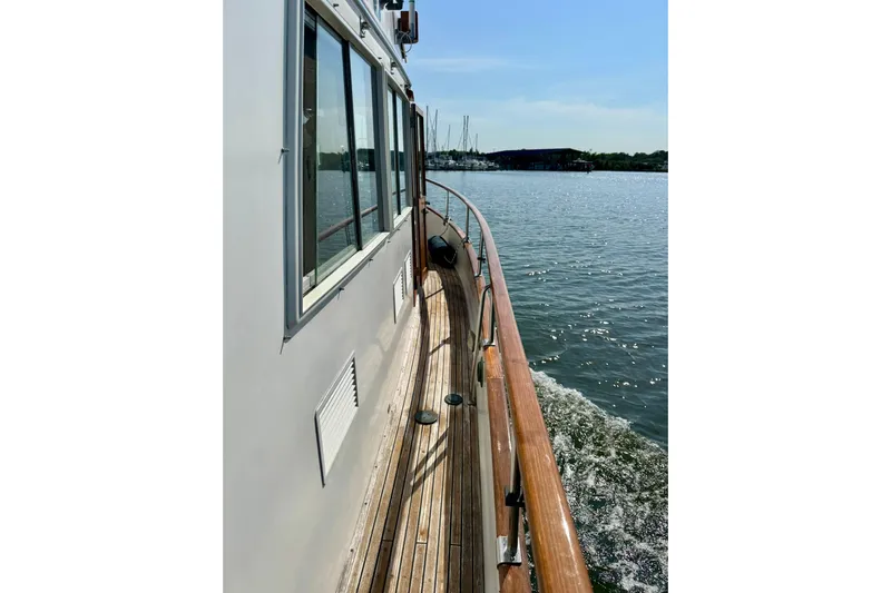  Yacht Photos Pics Side view of 1990 Grand Banks 36 Classic yacht cruising on calm waters.