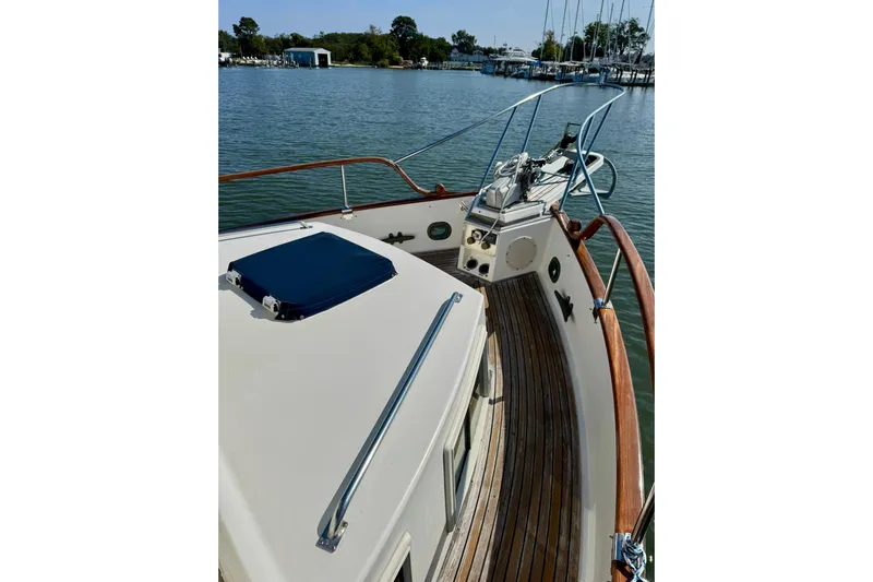  Yacht Photos Pics 1990 Grand Banks 36 Classic yacht deck with wooden railings and scenic marina view.