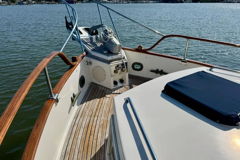  Yacht Photos Pics 1990 Grand Banks 36 Classic boat deck with wooden railings and water view.