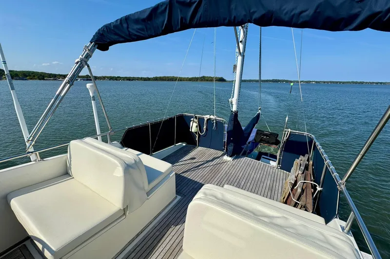  Yacht Photos Pics 1990 Grand Banks 36 Classic yacht deck with seating, overlooking calm waters.