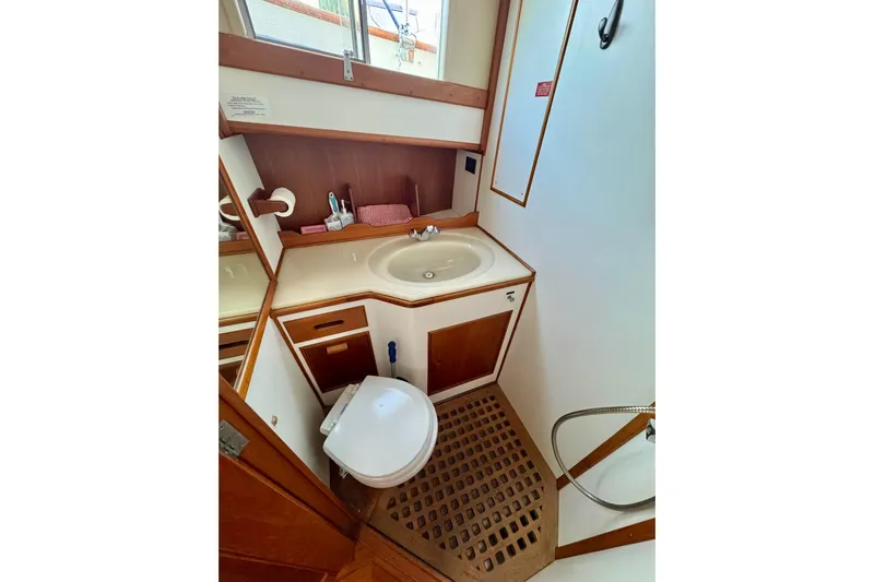  Yacht Photos Pics Bathroom interior of 1990 Grand Banks 36 Classic yacht, featuring sink and toilet.
