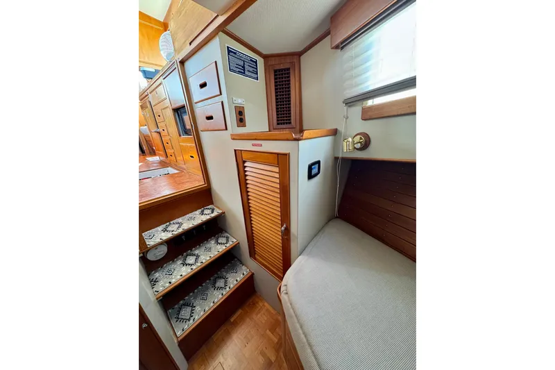  Yacht Photos Pics Interior of 1990 Grand Banks 36 Classic yacht with wooden stairs and cozy seating area.