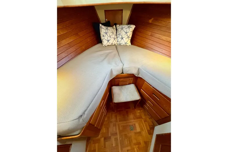  Yacht Photos Pics Cozy cabin interior of 1990 Grand Banks 36 Classic with wooden paneling and twin beds.