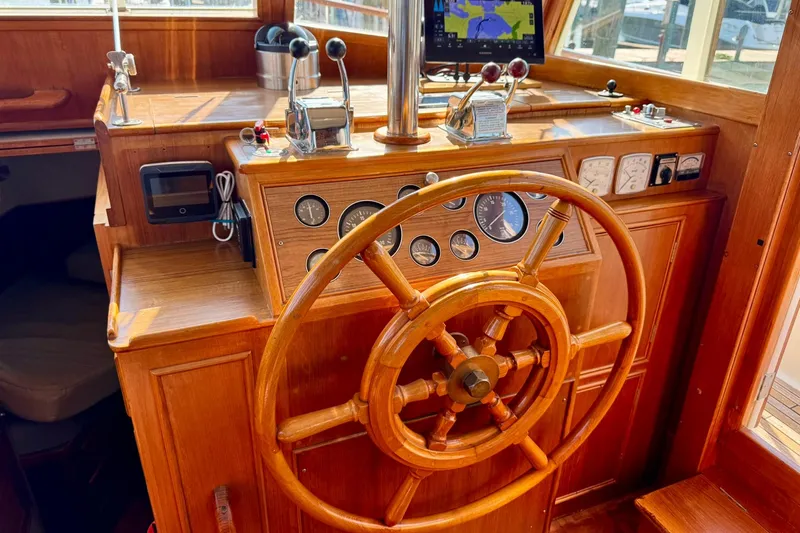  Yacht Photos Pics 1990 Grand Banks 36 Classic helm with wooden wheel and navigation instruments.