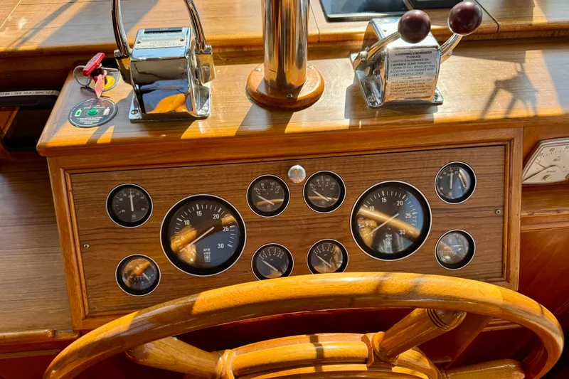  Yacht Photos Pics 1990 Grand Banks 36 Classic helm with wooden wheel and instrument panel.