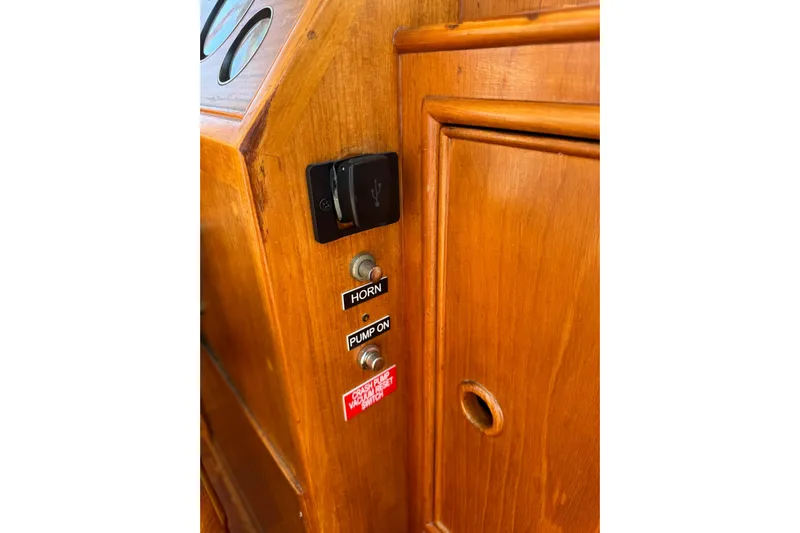  Yacht Photos Pics Wooden control panel of 1990 Grand Banks 36 Classic with horn and pump switches.