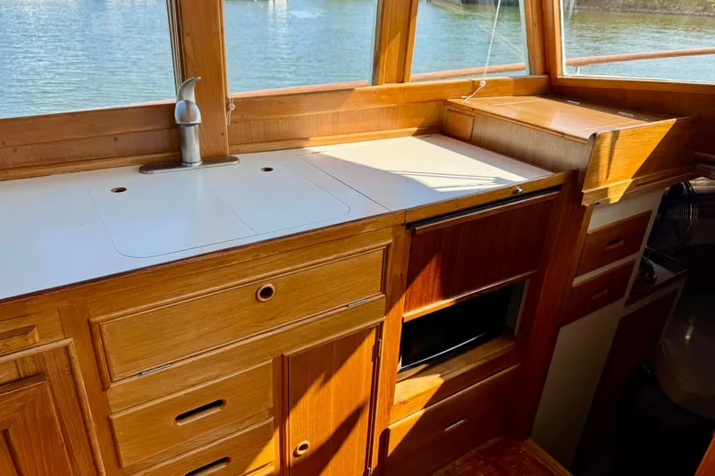  Yacht Photos Pics Interior of 1990 Grand Banks 36 Classic yacht with wooden cabinetry and sink.