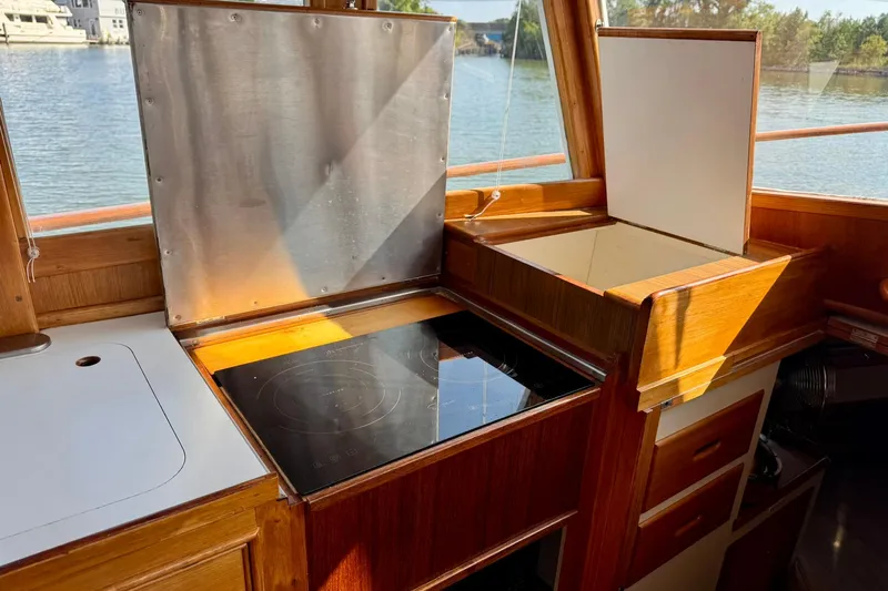  Yacht Photos Pics 1990 Grand Banks 36 Classic yacht kitchen with stove and wooden cabinetry.