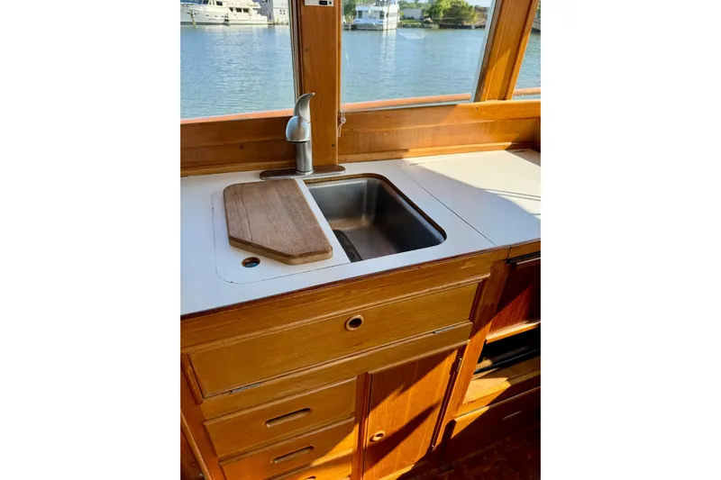 Yacht Photos Pics 1990 Grand Banks 36 Classic yacht kitchen with sink and wooden cabinetry.