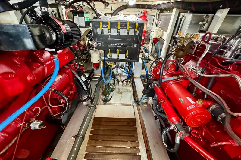 Yacht Photos Pics Engine room of 1990 Grand Banks 36 Classic with red machinery and control panel.