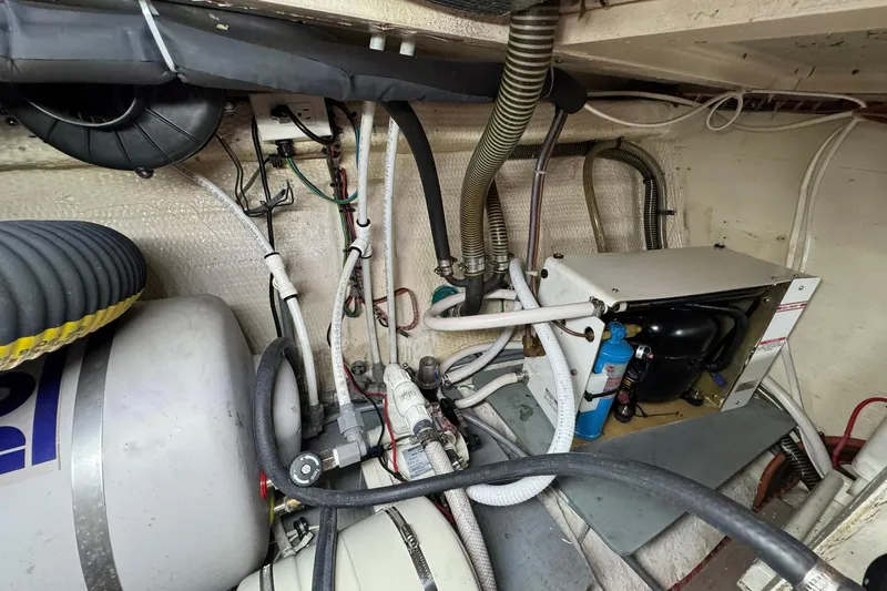  Yacht Photos Pics Engine room of 1990 Grand Banks 36 Classic with various mechanical components and wiring.