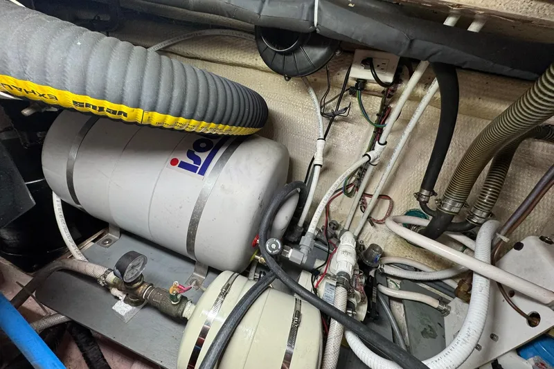  Yacht Photos Pics Engine room of 1990 Grand Banks 36 Classic with various pipes and equipment.