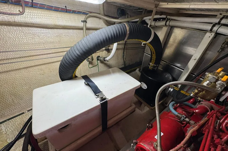  Yacht Photos Pics Engine room of a 1990 Grand Banks 36 Classic boat, featuring hoses and machinery.