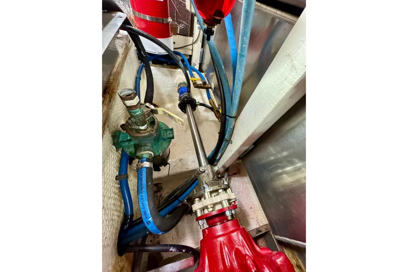  Yacht Photos Pics Engine room of 1990 Grand Banks 36 Classic with visible hoses and machinery.