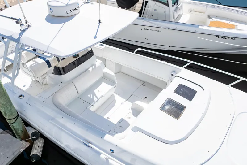  Yacht Photos Pics 2003 Intrepid 370 Cuddy boat docked, featuring spacious seating and Garmin equipment.