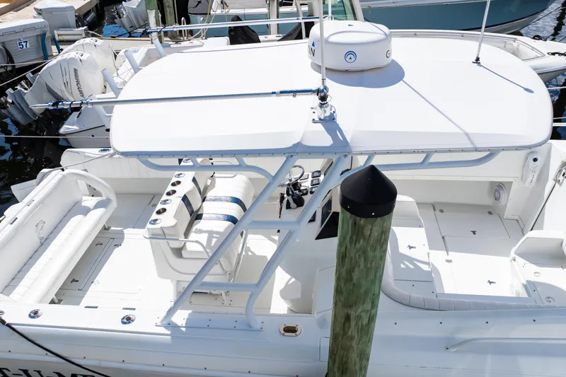  Yacht Photos Pics 2003 Intrepid 370 Cuddy boat docked, featuring spacious seating and sleek design.