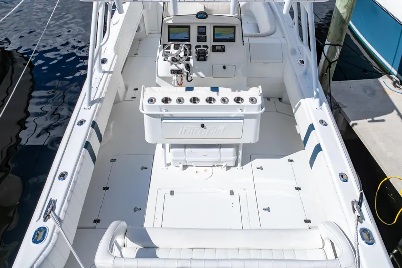  Yacht Photos Pics 2003 Intrepid 370 Cuddy boat interior with helm, seating, and fishing rod holders.