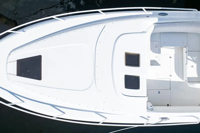  Yacht Photos Pics Top view of a 2003 Intrepid 370 Cuddy boat, showcasing sleek white design.