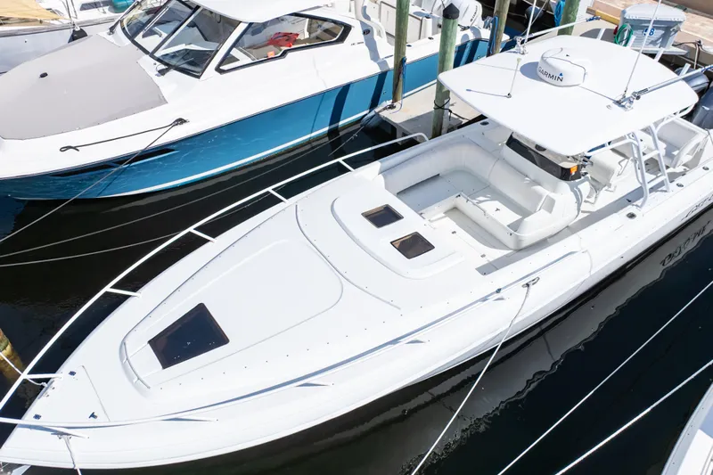  Yacht Photos Pics 2003 Intrepid 370 Cuddy boat docked, featuring sleek design and spacious seating area.