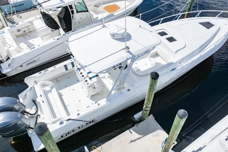  Yacht Photos Pics 2003 Intrepid 370 Cuddy boat docked, featuring spacious deck and dual engines.