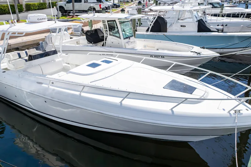  Yacht Photos Pics 2003 Intrepid 370 Cuddy boat docked at marina, featuring sleek white design.
