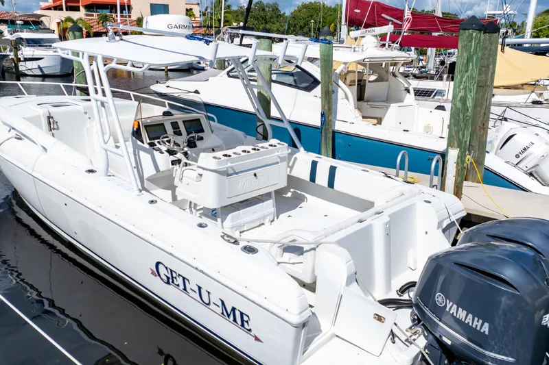  Yacht Photos Pics 2003 Intrepid 370 Cuddy boat docked with Yamaha engines, marina background.