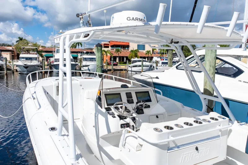  Yacht Photos Pics 2003 Intrepid 370 Cuddy boat docked, featuring Garmin navigation, white exterior, and marina backdrop.