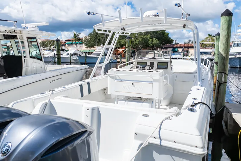  Yacht Photos Pics 2003 Intrepid 370 Cuddy boat docked at marina, featuring Garmin equipment.
