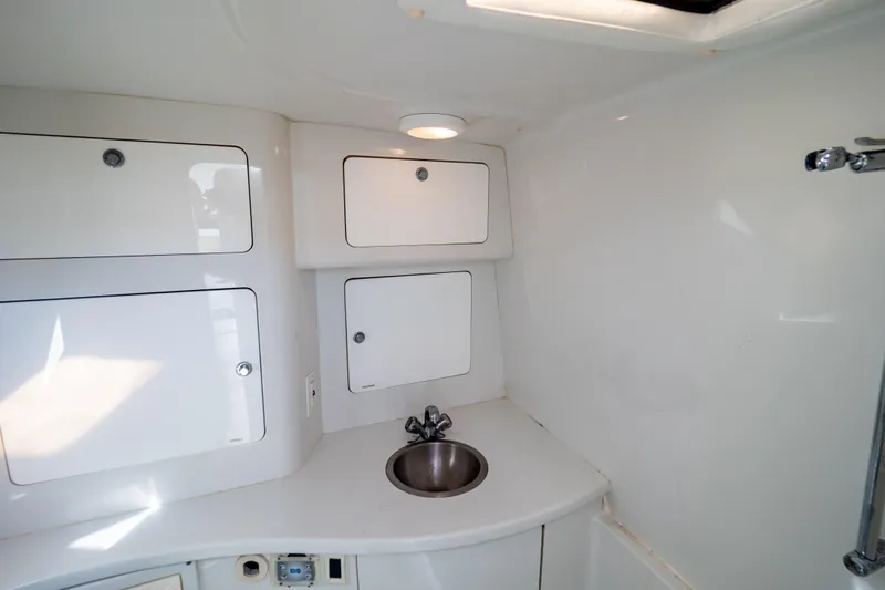  Yacht Photos Pics 2003 Intrepid 370 Cuddy interior with sink and storage cabinets.