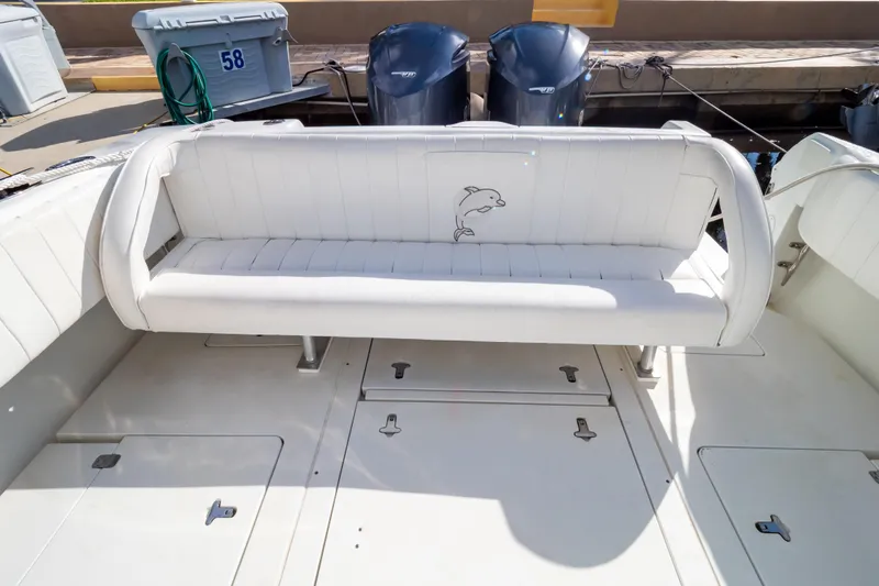  Yacht Photos Pics 2003 Intrepid 370 Cuddy boat with white cushioned seating and dolphin embroidery.