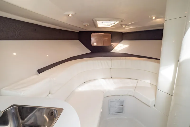  Yacht Photos Pics 2003 Intrepid 370 Cuddy cabin interior with white seating and overhead lighting.