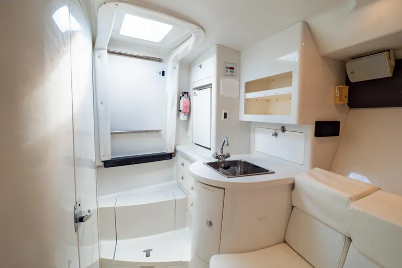  Yacht Photos Pics 2003 Intrepid 370 Cuddy interior with sink, seating, and storage compartments.