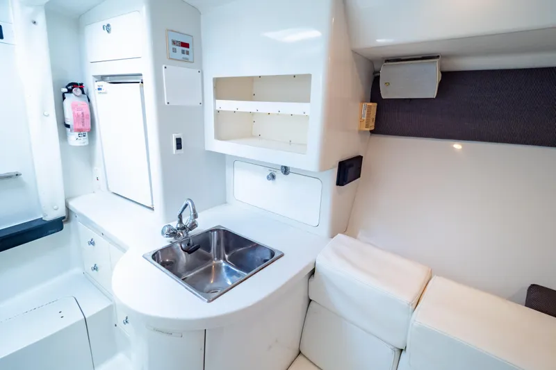  Yacht Photos Pics 2003 Intrepid 370 Cuddy interior with sink, storage, and seating area.